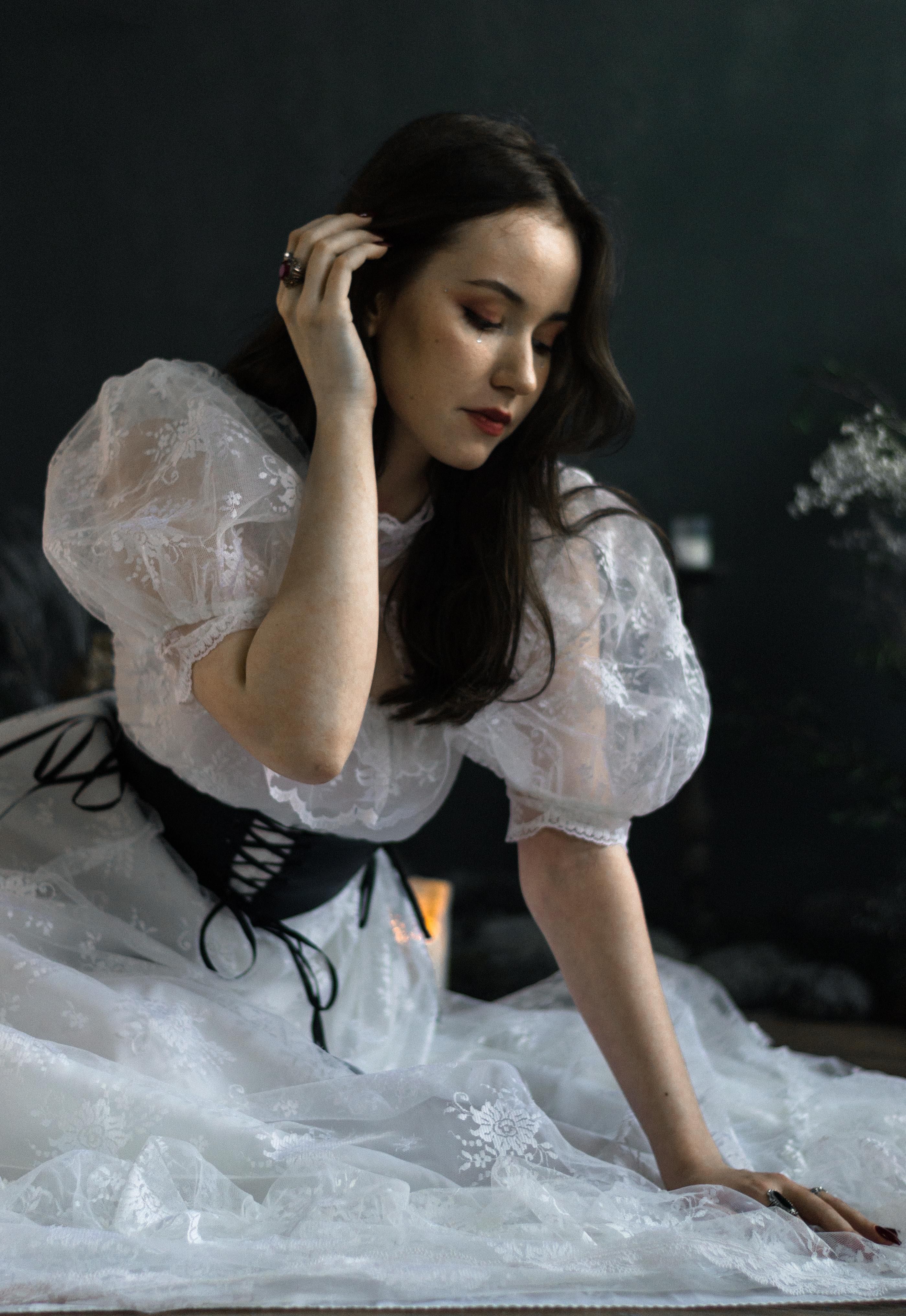 Young Brunette in a White Dress Sitting on the Floor · Free Stock Photo