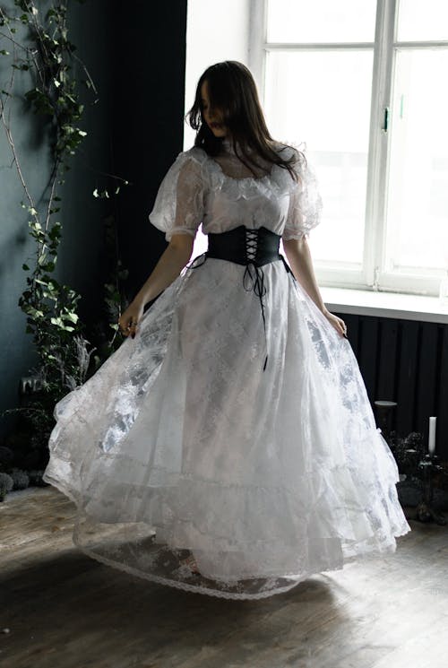 Young Woman in White Lace Dress and Cinch Belt
