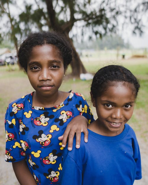 Little Girls in Blue T-shirts Standing Outdoors 