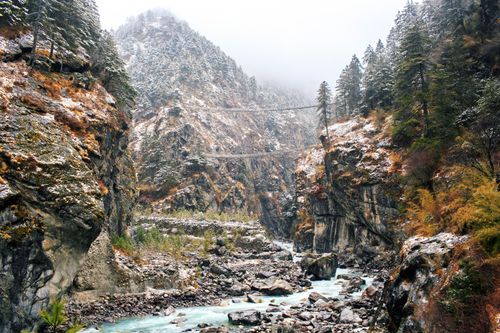 Free A breathtaking view of a rocky canyon with a tranquil stream flowing through in a winter setting. Stock Photo