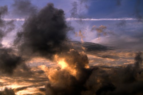 Free A Dramatic Sky with Dark Clouds at Sunset  Stock Photo