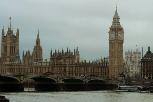 Free Majestic view of Big Ben and Westminster Bridge in London, UK, under a cloudy sky. Stock Photo