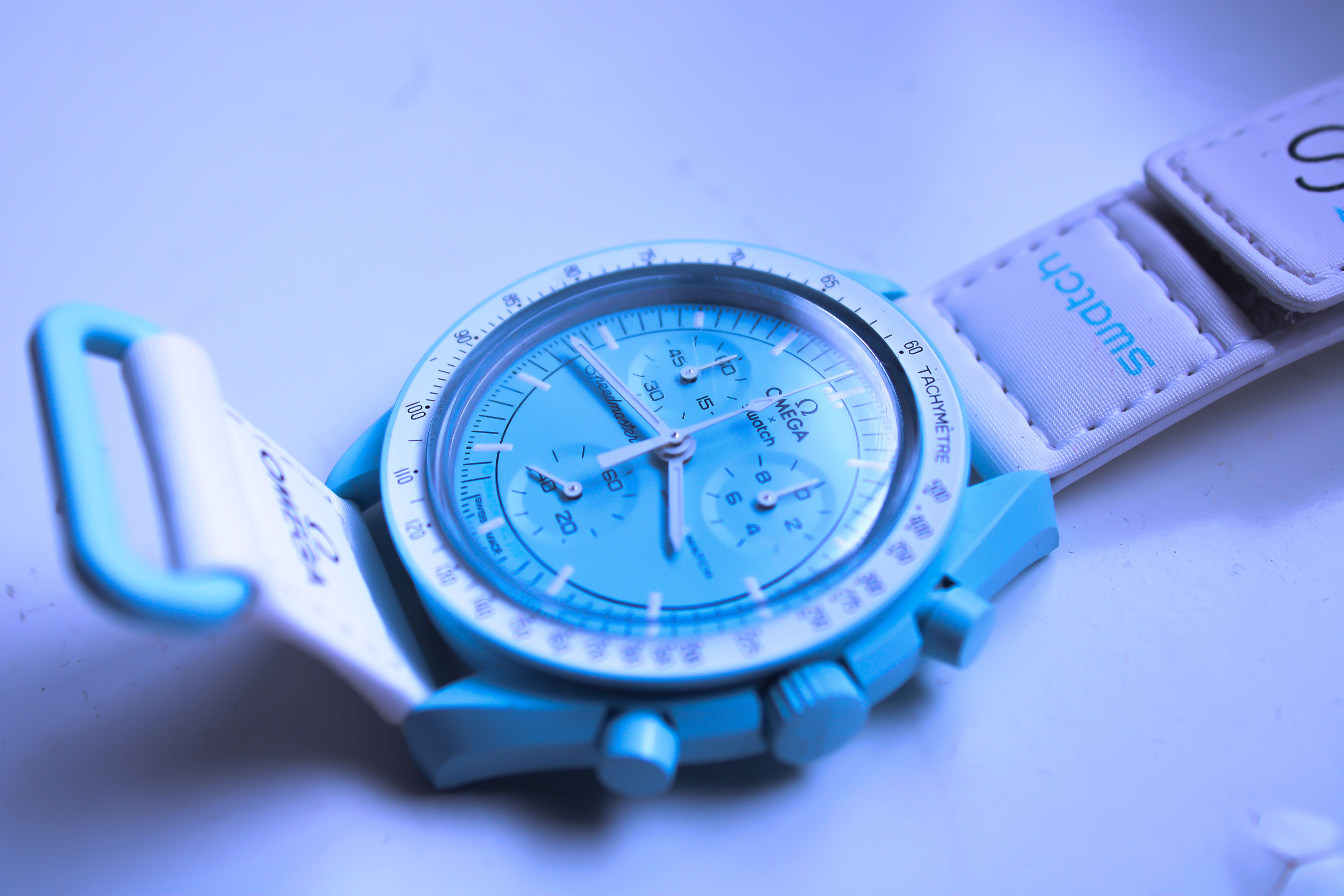 A high-quality image showcasing a stylish blue wristwatch with a white strap and luxurious design.