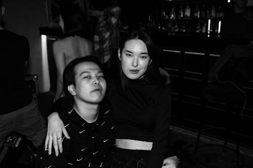 Black and White Photograph of a Couple Posing in a Dark Interior