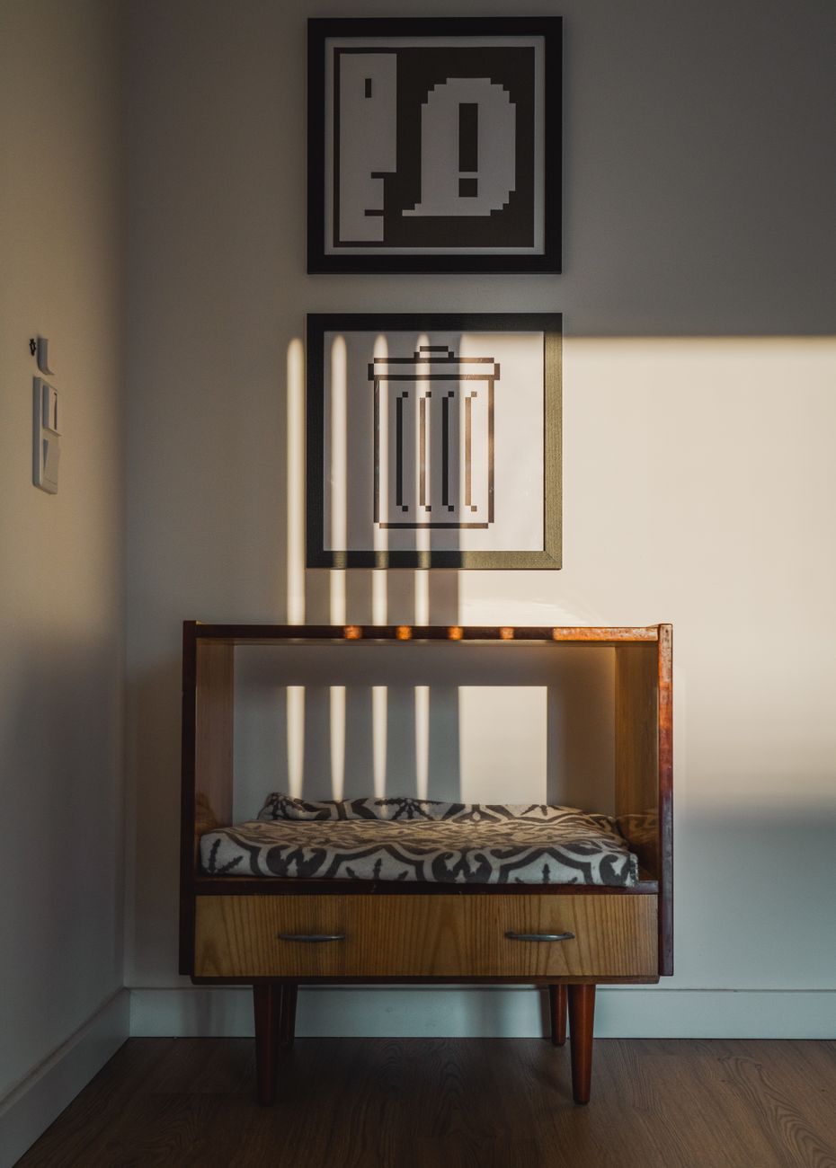 Cozy mid-century modern furniture illuminated by sunlight, featuring geometric artwork and a warm wooden floor.. pexels, cozy