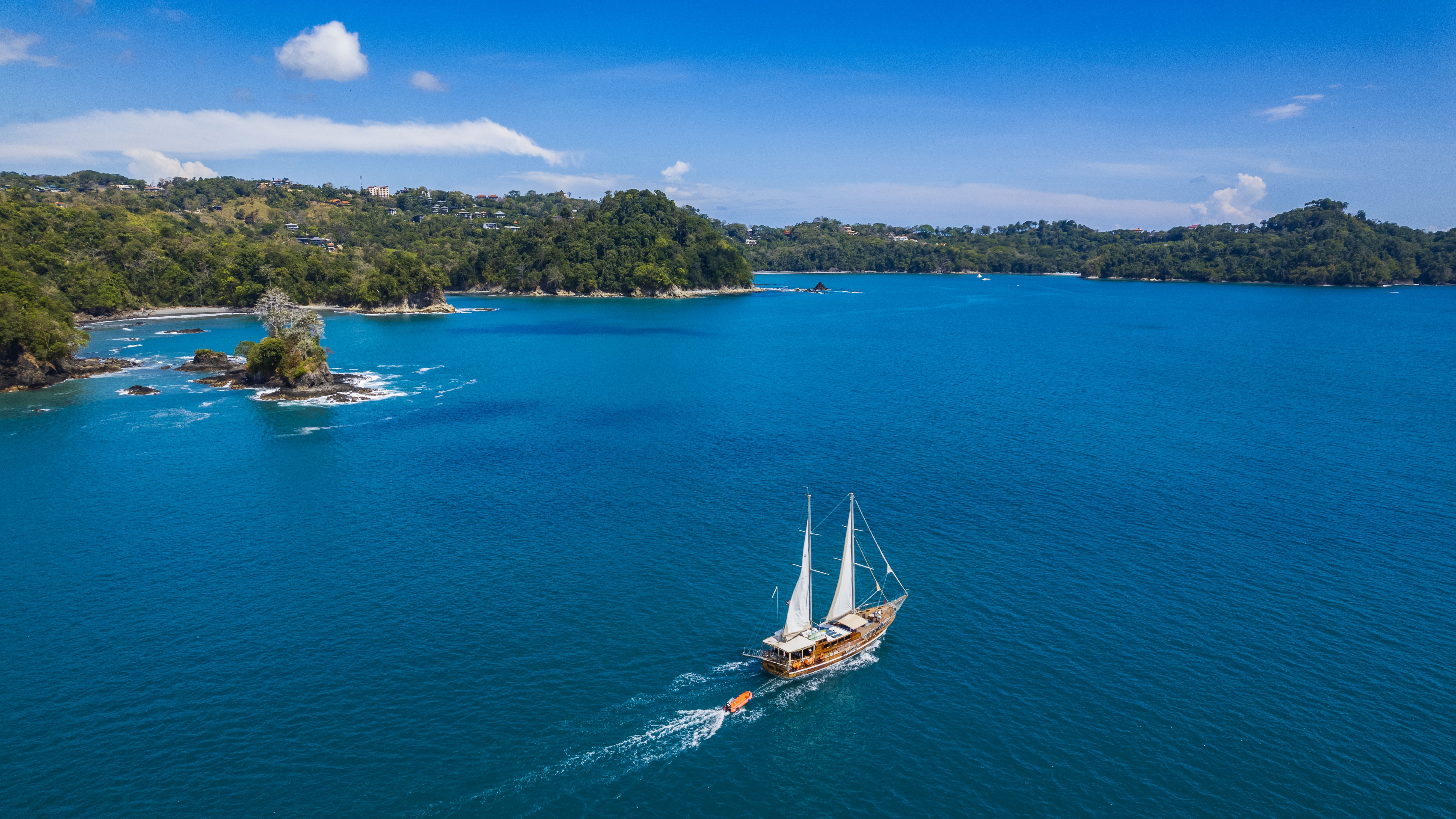 Stunning aerial view of a sailboat cruising the waters near Quepos, Costa Rica.