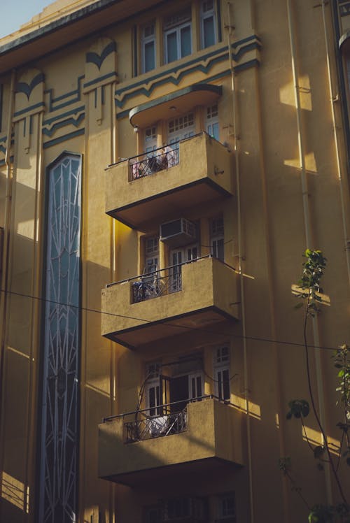 Yellowish Art Deco Building Facade with Balconies
