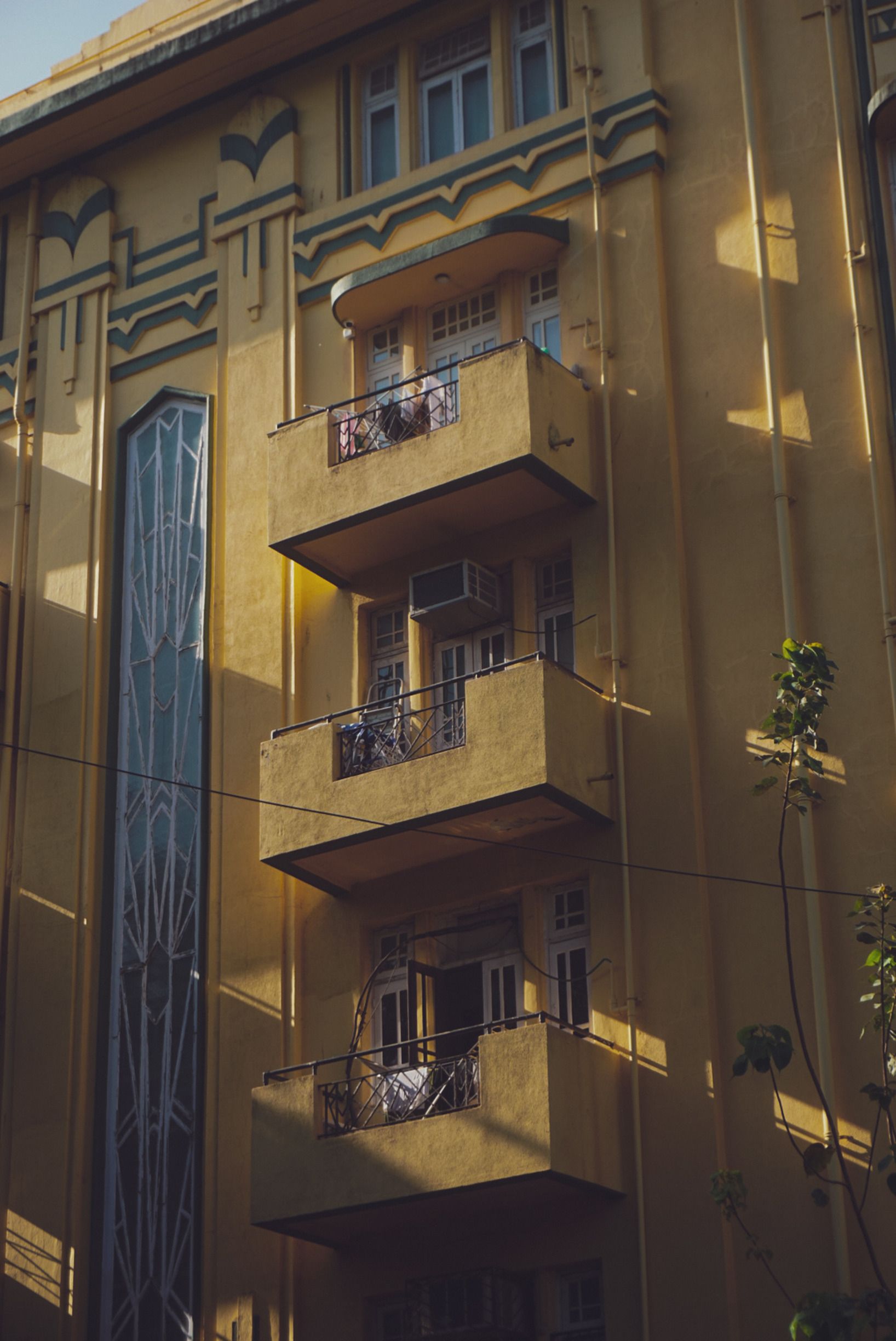 Yellowish Art Deco Building Facade with Balconies · Free Stock Photo