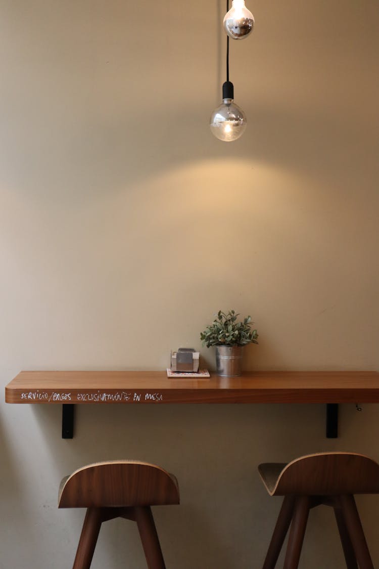 Table And Chairs By Wall At Cafe