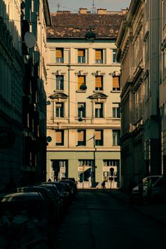 Charming urban scene of residential buildings in Budapest, showcasing classic architecture and warm evening light.
