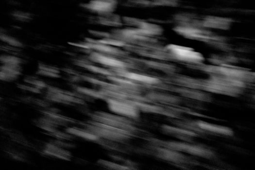 A captivating abstract black and white photo with blurred motion, evoking mystery and depth.
