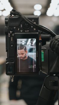 Close-up of a photographer capturing a scene in Miami using advanced camera technology.