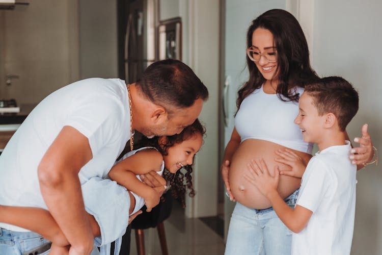 Happy Family With Pregnant Mother