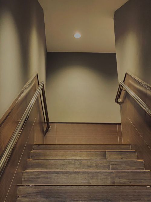 Free A contemporary wooden staircase with metal railings, viewed from above indoors. Stock Photo
