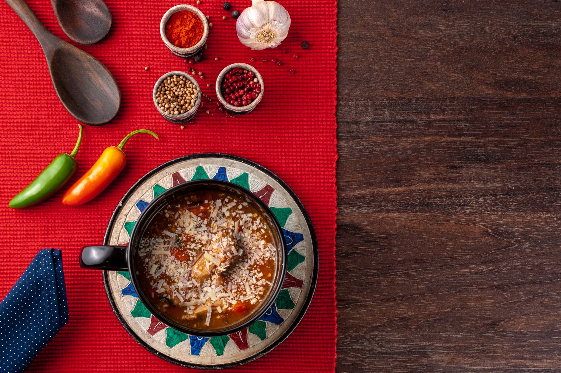 Bowl of hot spicy tortilla soup topped with cheese and cilantro