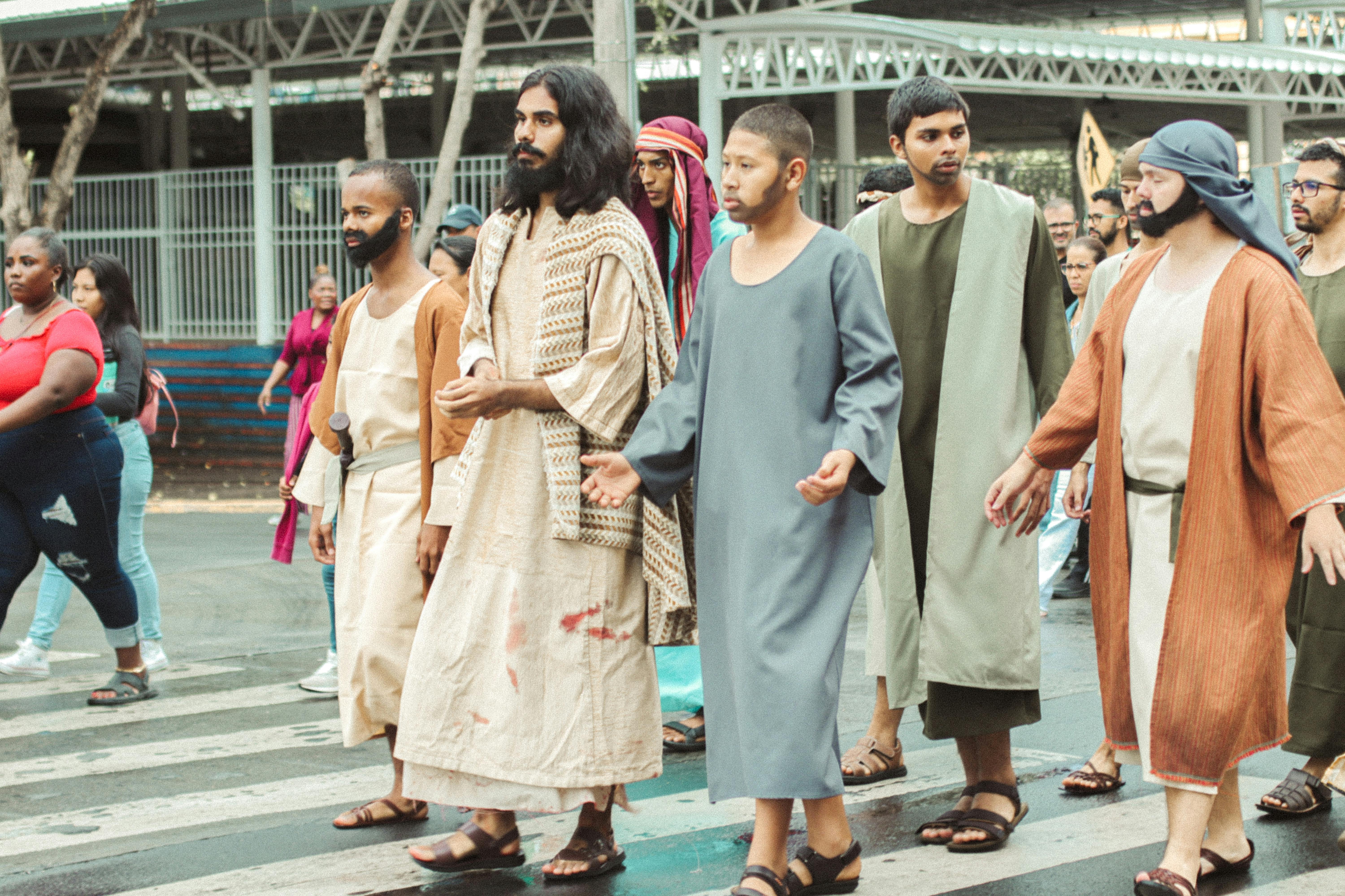 Free Live reenactment of biblical disciples walking through city streets. Stock Photo