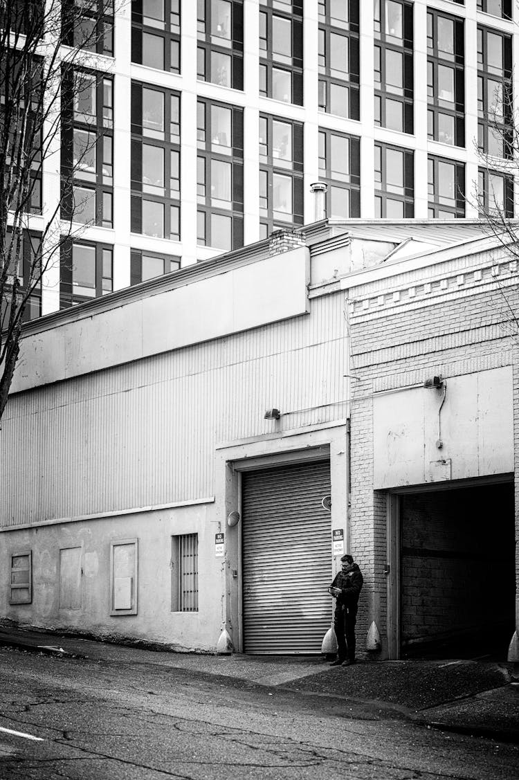 Man Standing In Front Of An Open Garage