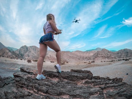 Low Angle Shot of Woman Flying a Drone