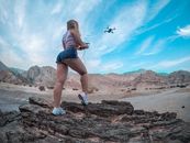 Low Angle Shot of Woman Flying a Drone