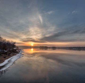 Serene winter sunset over the Mississippi River in Reads Landing, Minnesota.