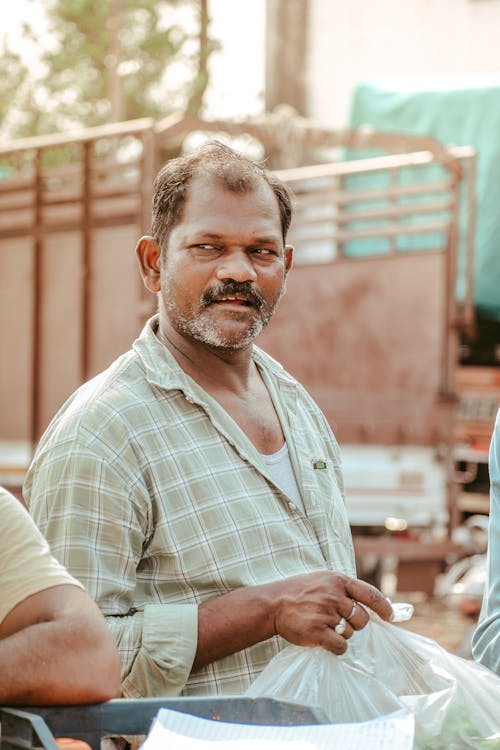 Man in Shirt Holding Bag