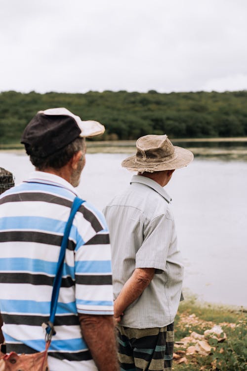 Candid Picture of Elderly Men Standing on the Shore 