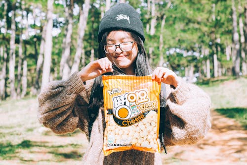 Free Selective Focus Photography of Girl Holding Popcorn Pack Stock Photo