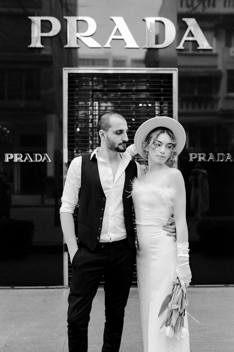 Elegant Man And Woman In Front Of A Prada Store