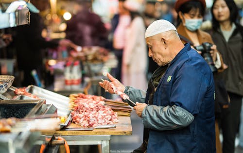 Man Sticking Meat On Stick