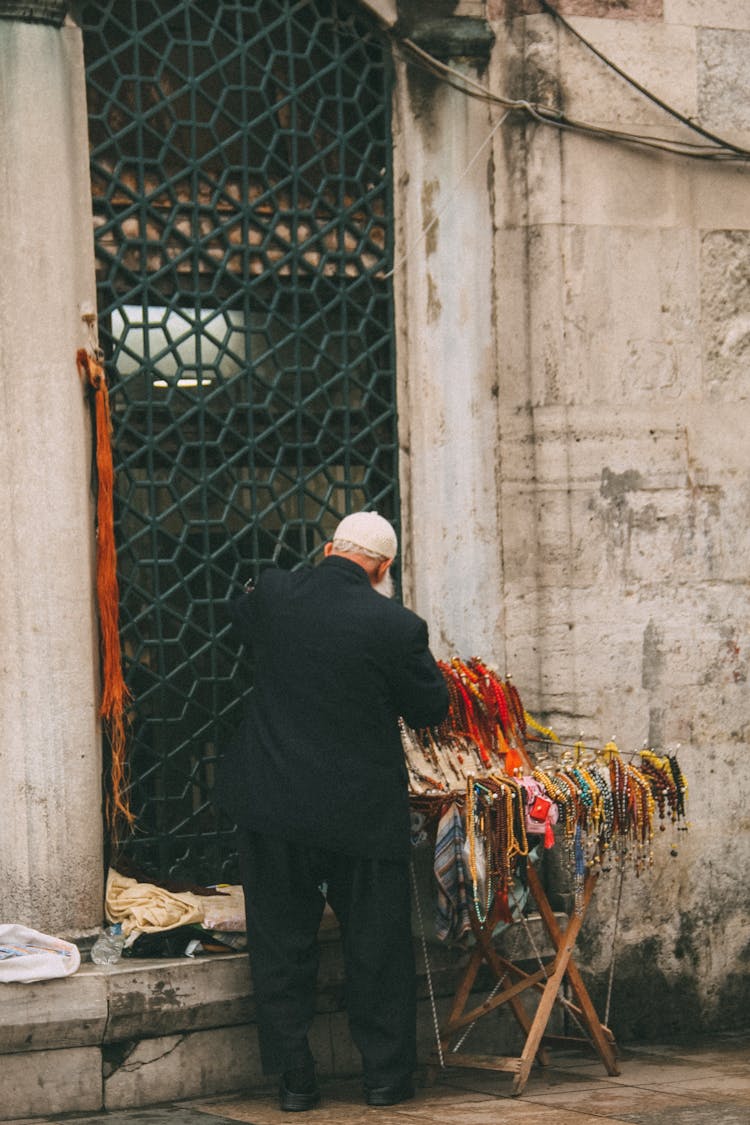 Old Man Selling Necklace On City Street