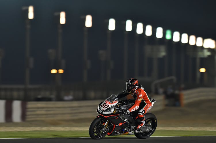 Person Riding Super Bike During Night Race