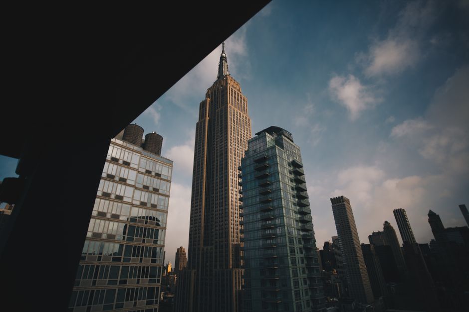 Low angle view of the Empire State Building amid New York City's modern skyline.