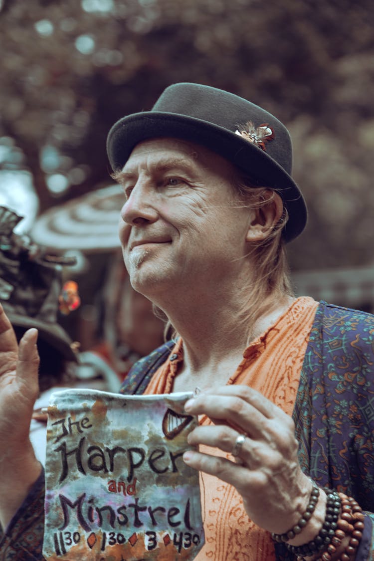 Man In Hat Holding Banner