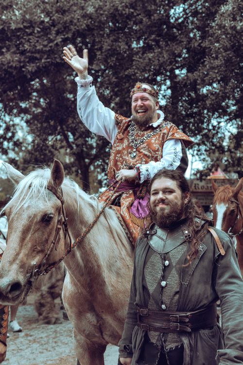 Free Lively medieval reenactment with performers in costume. Captures historical charm and entertainment. Stock Photo