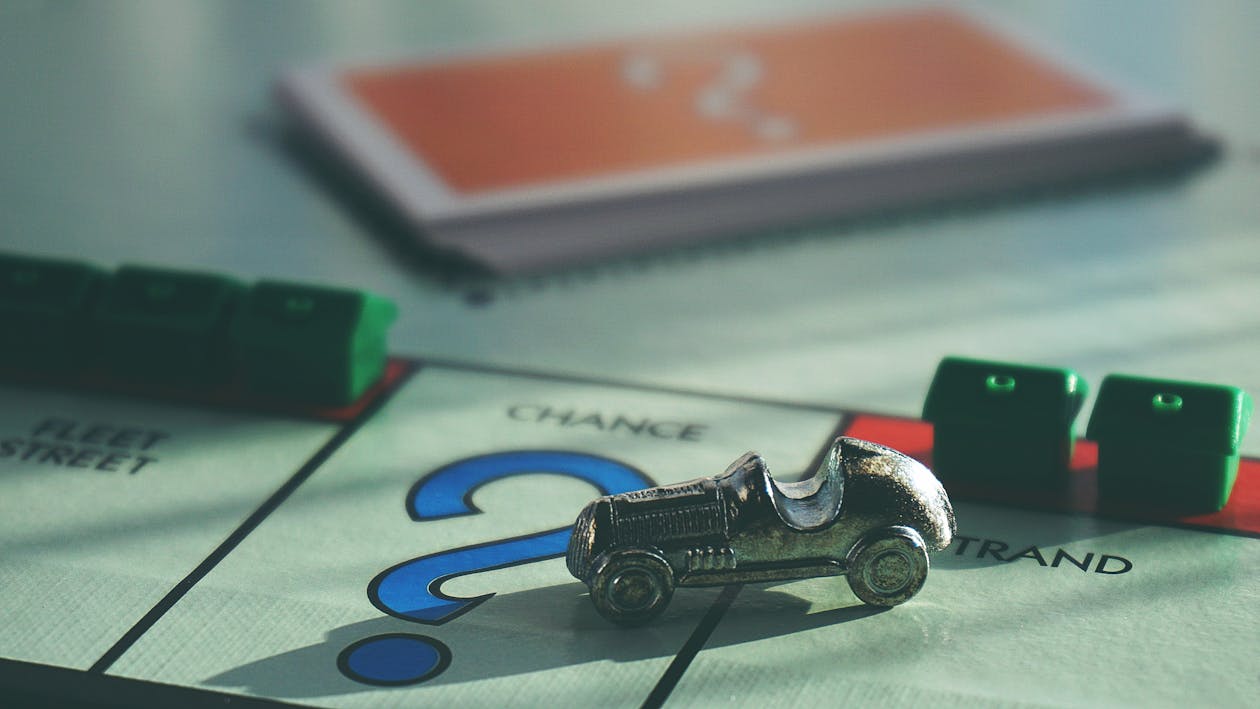 Miniature Toy Car on Top of Board Game 