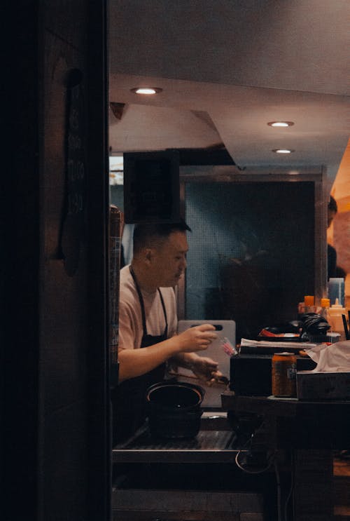 Man Working in Kitchen and Cooking