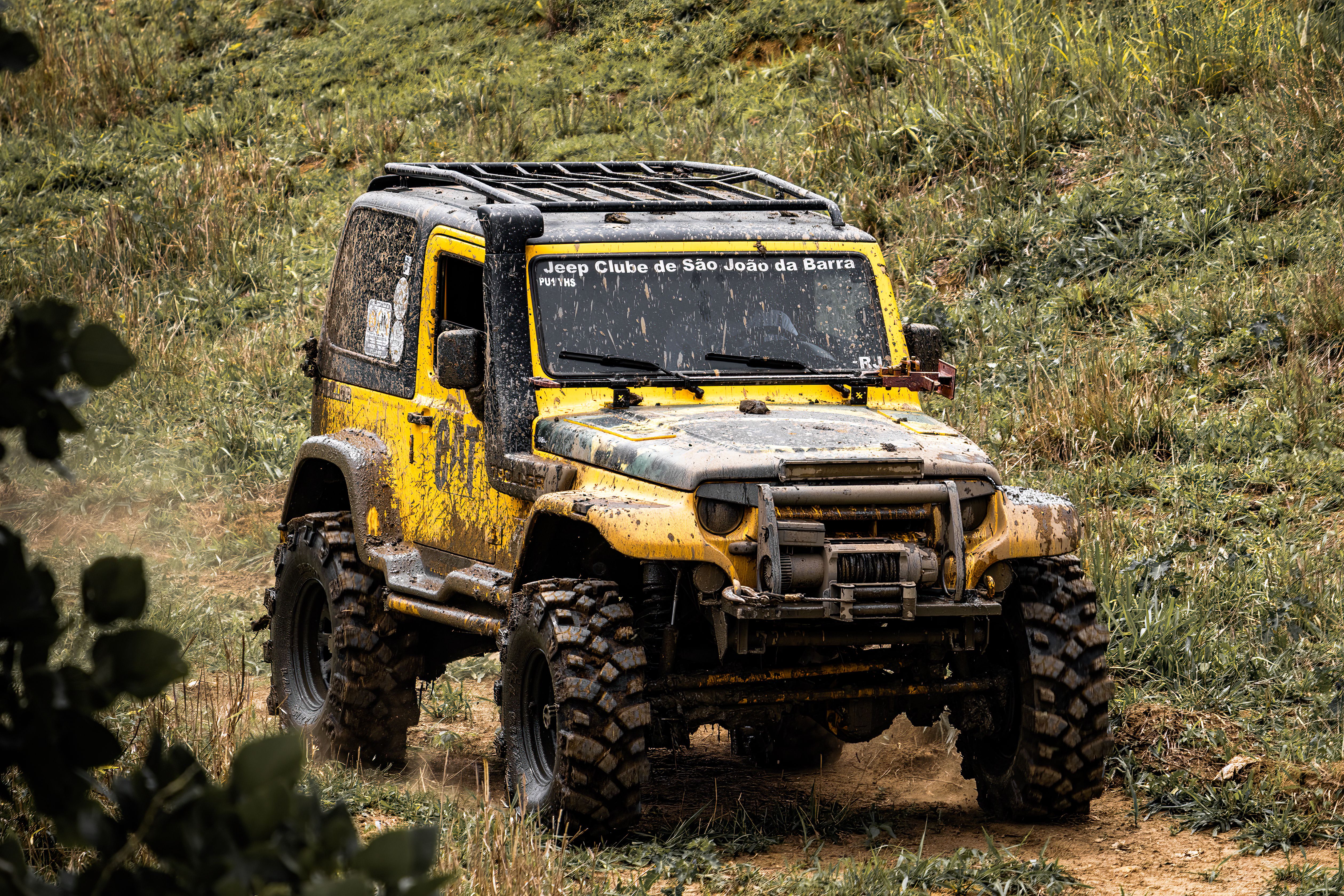 A rugged yellow offroad vehicle on a dirt trail, showcasing adventure and durability.