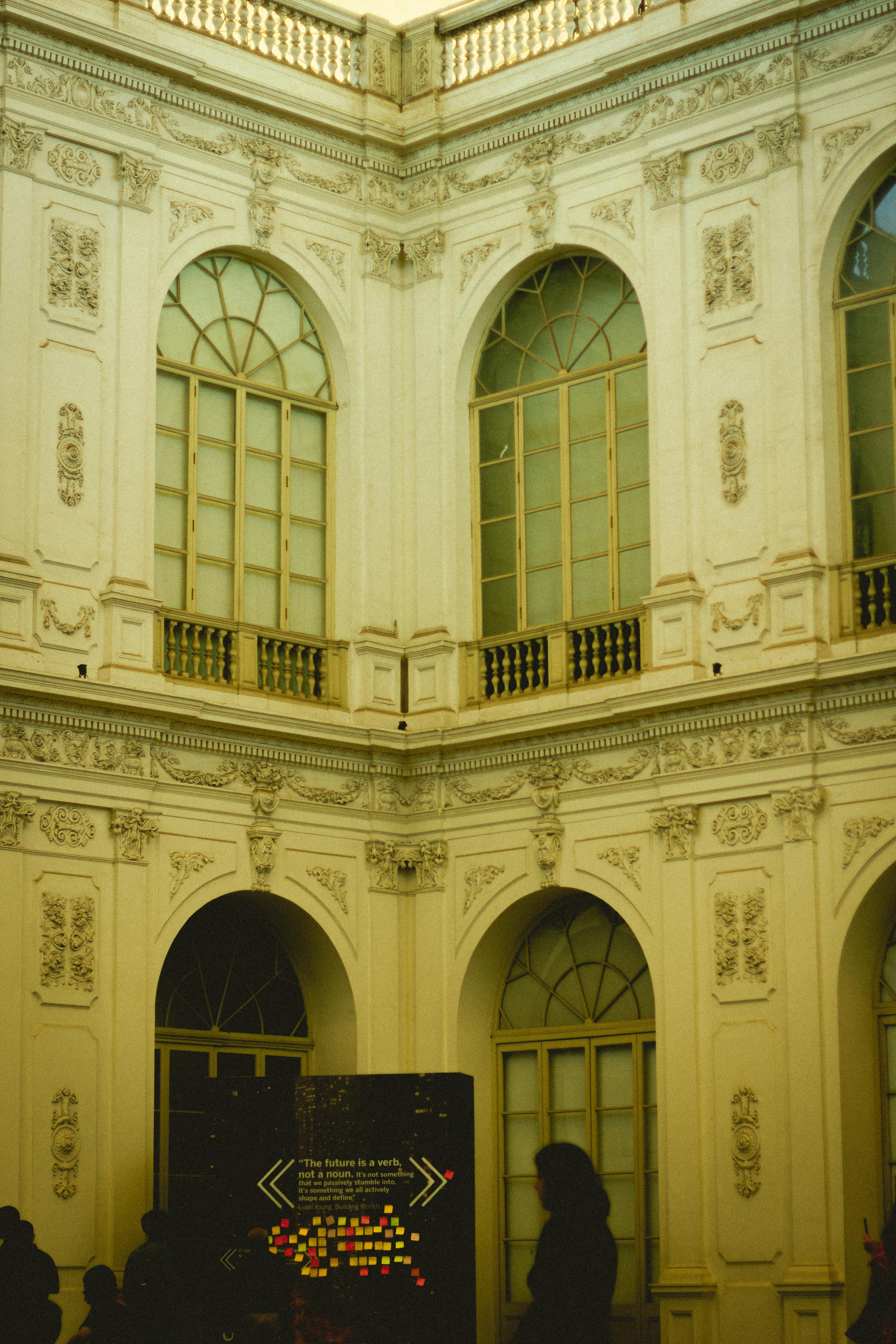 Ornamented historical building facade featuring arched windows and intricate reliefs.