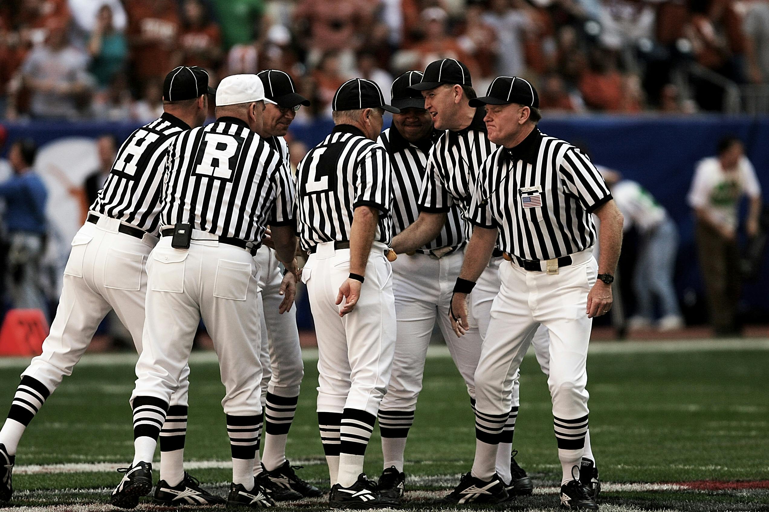 8 Football Referees In The Field · Free Stock Photo