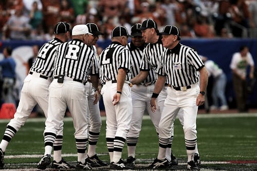 Free 8 Football Referees in the Field Stock Photo