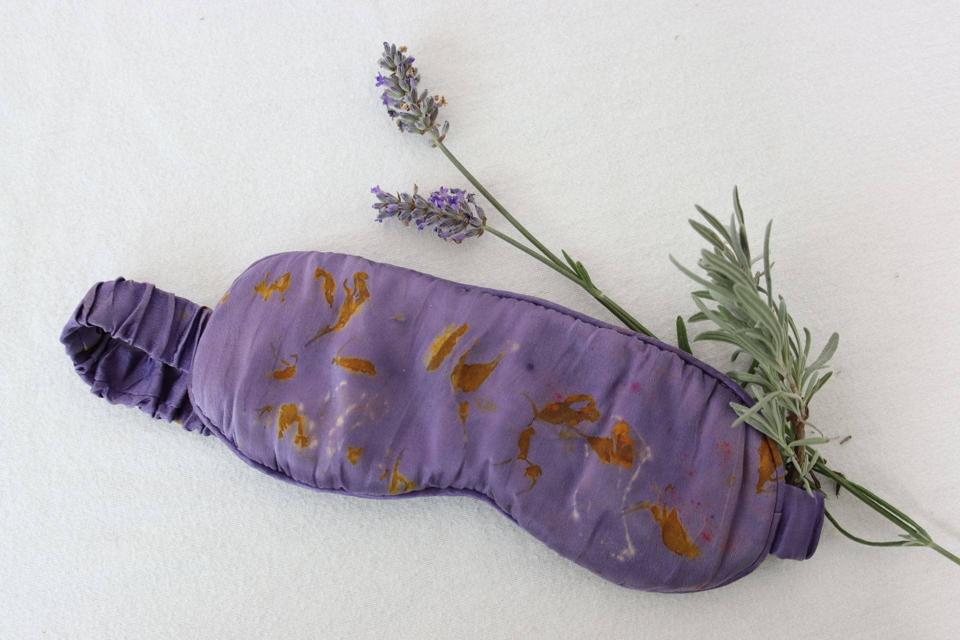Purple sleep mask with lavender sprigs, perfect for relaxation and restful sleep.
