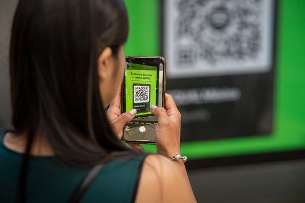 Customer scanning a QR code at a cafe counter