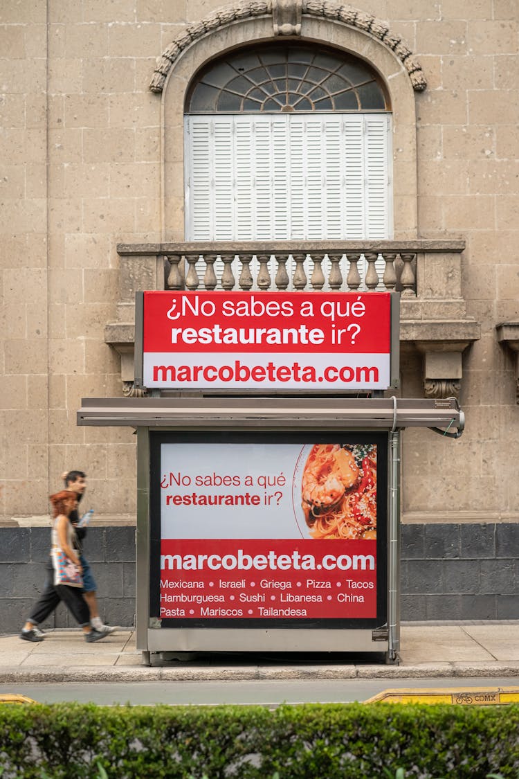 People Walking Near Advertisement