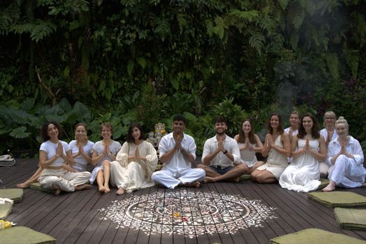 A diverse group practicing yoga outdoors, fostering unity and relaxation in nature.