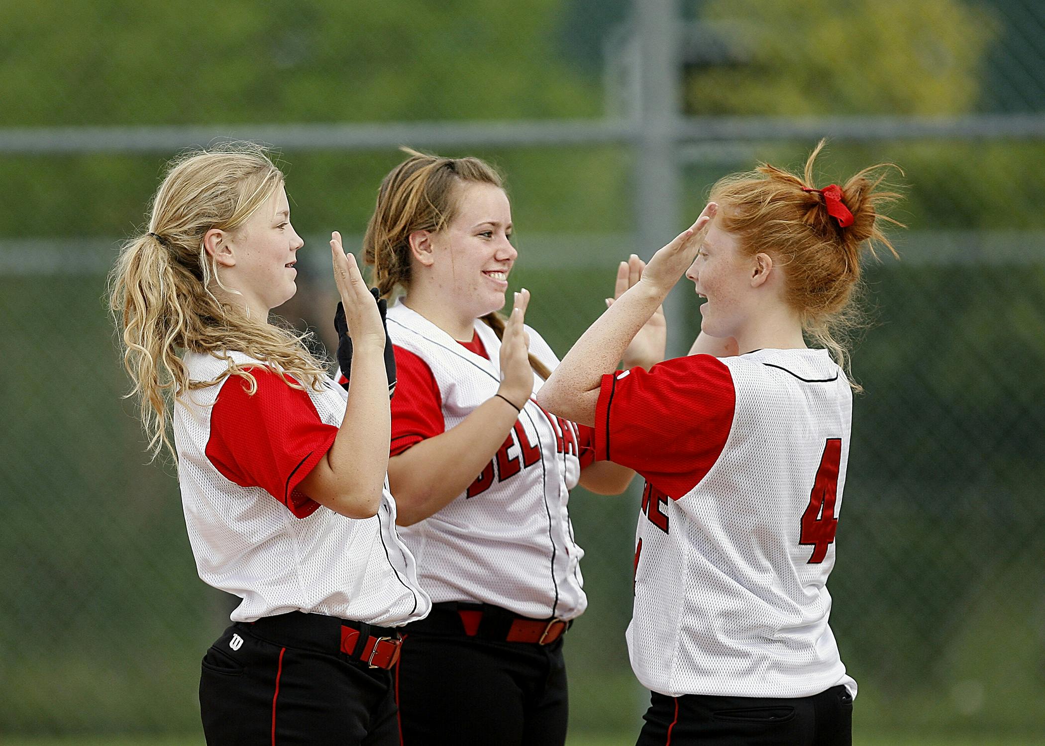 girls on white red jersey playing hand game