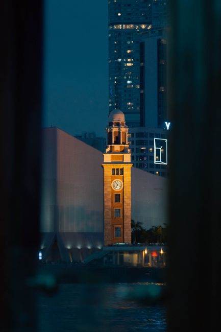 Iconic Clock Tower in Hong Kong lit up beautifully during nighttime.
