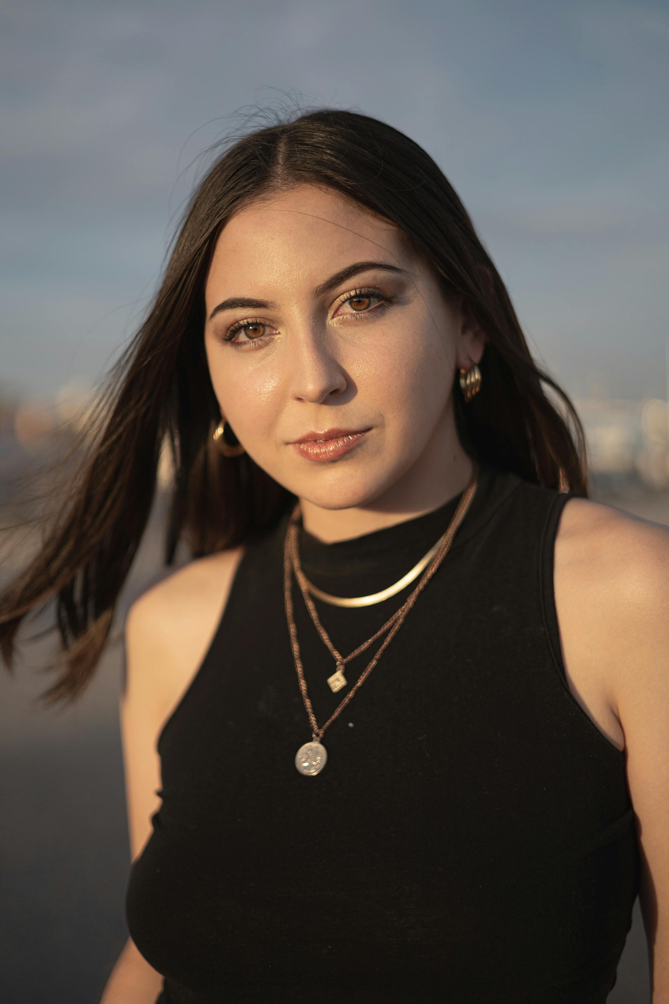 a woman with long hair and a necklace