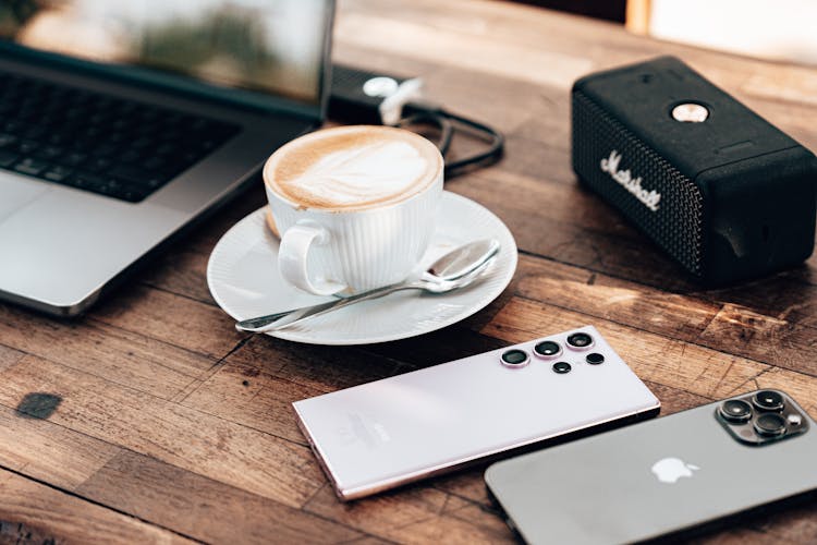 Coffee And Smartphones On Wooden Table