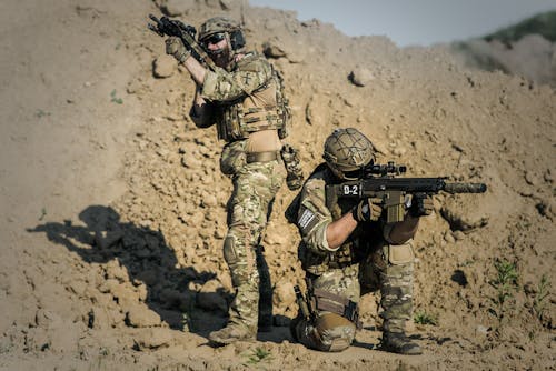 Dua Pria Berseragam Tentara Dengan Senjata