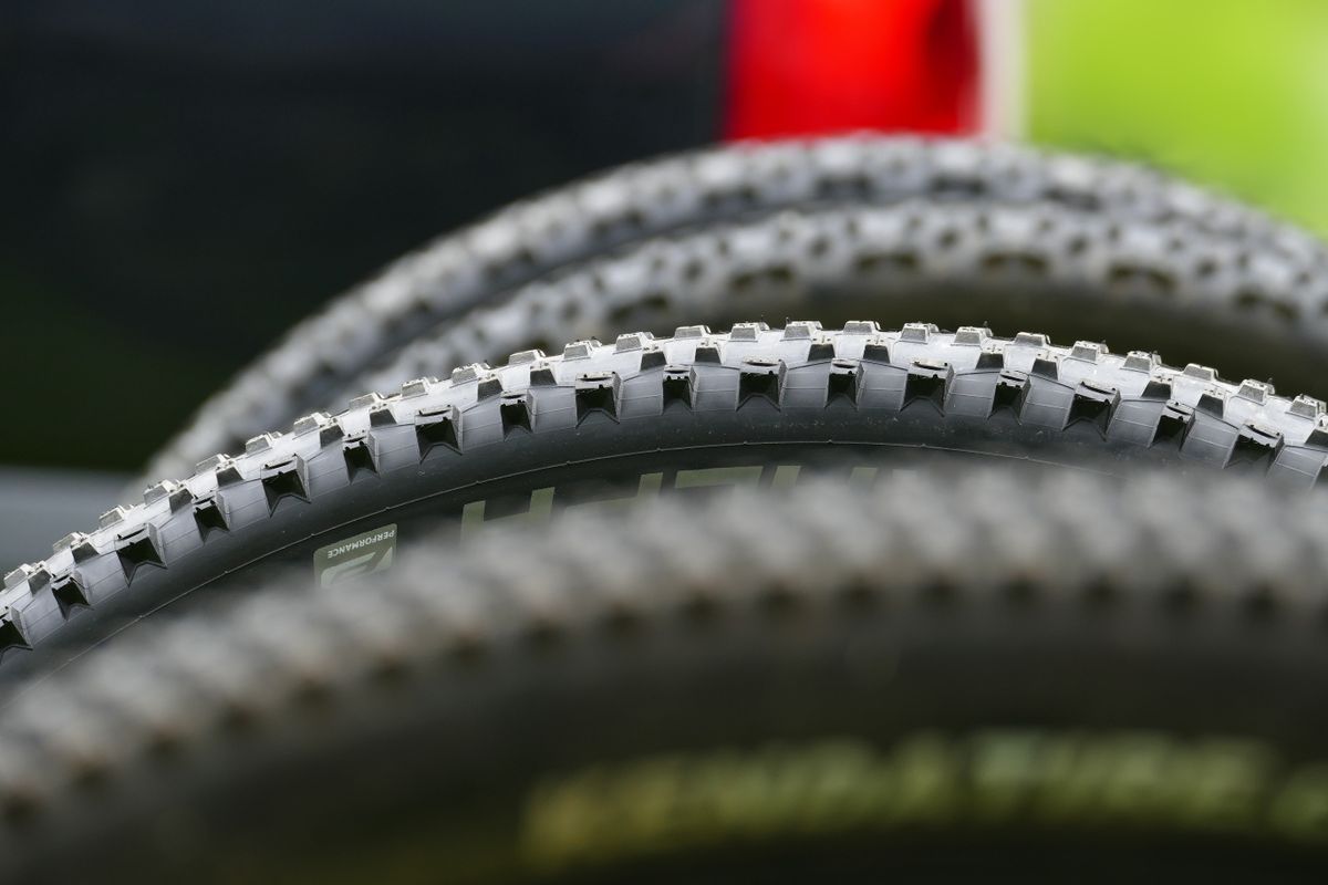 Mountain bike tire closeup showing aggressive tread pattern for off-road trail riding